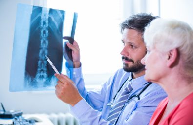 Doctor discussing x-ray with patient Doctor discussing x-ray with patient at the hospital