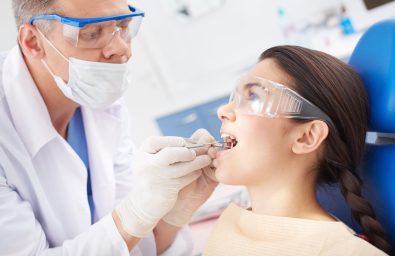 Dental hygiene Young girl with open mouth during oral checkup at the dentists